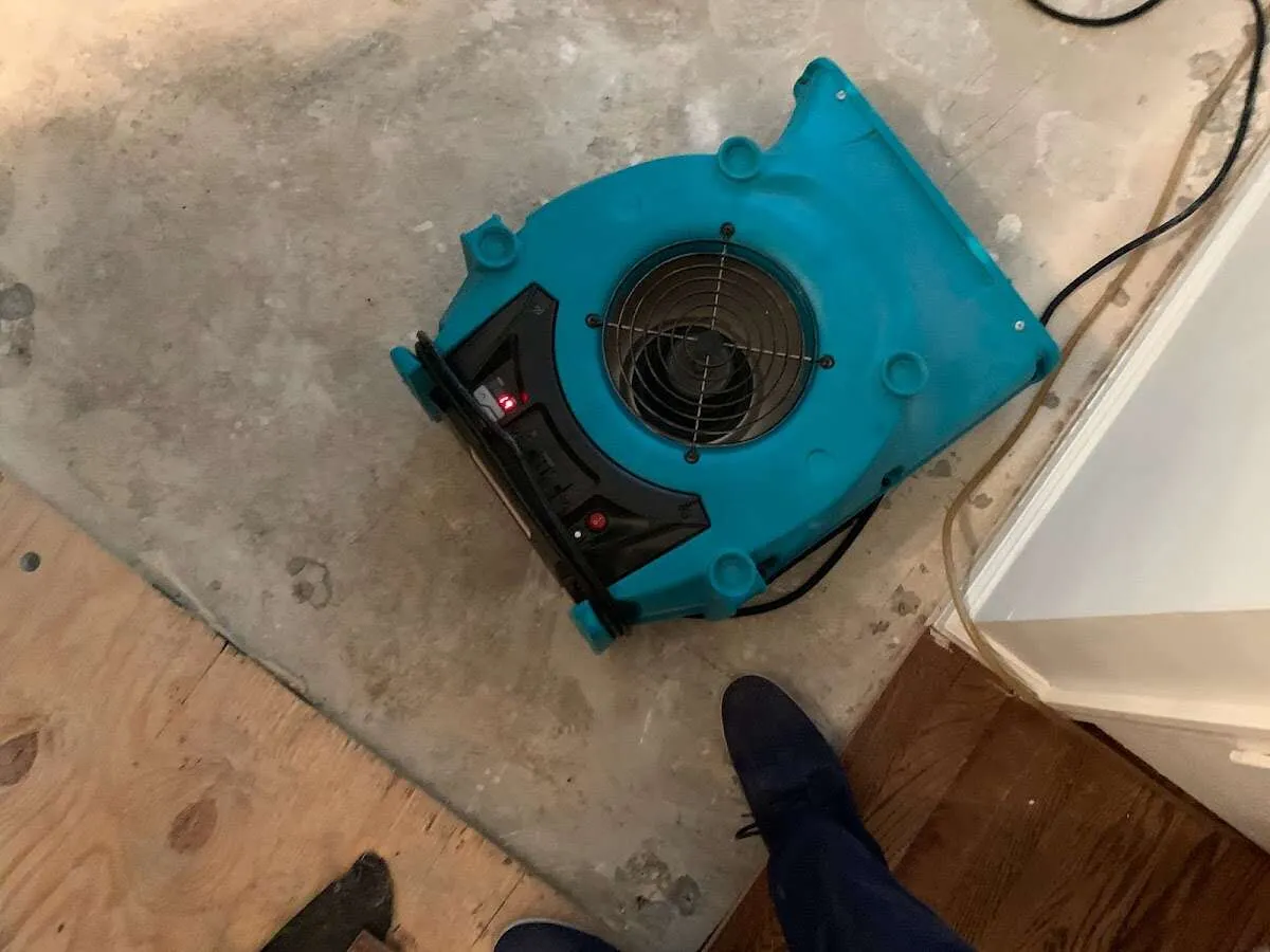 Air mover drying subfloor during Leak Detection & Repair in Humboldt